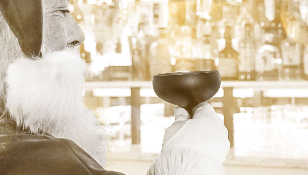 sepia tone image of santa with a cocktail glass at Library by the Sea